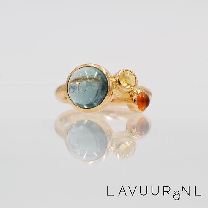 Gouden ring met grote ronde topaas en twee kleinere ronde citrienen aan de rechterkant